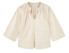 Girl wearing MIRTH women's v neck ruched collar three quarter sleeve palm springs top in parchment beige cotton poplin