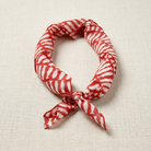 Red and white striped bandana on a beige fabric background