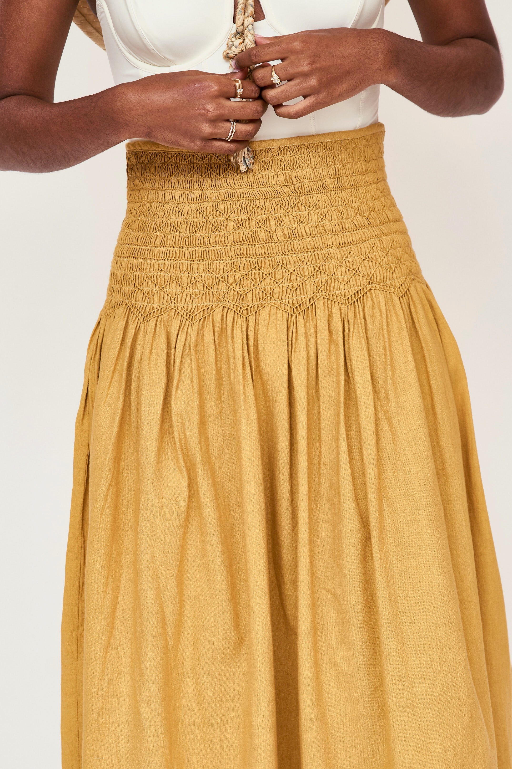 Girl wearing MIRTH women's smocked elastic waist savannah skirt set in yellow gilded cotton