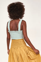 Girl wearing MIRTH women's smocked elastic savannah sleeveless cropped top set in blue frost cotton