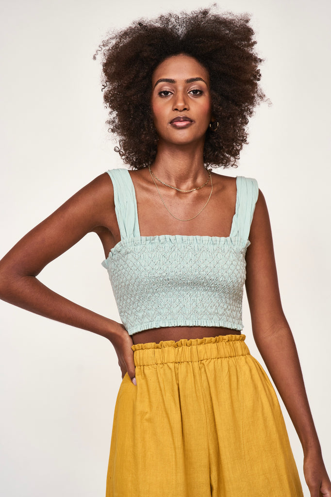 Girl wearing MIRTH women's smocked elastic savannah sleeveless cropped top set in blue frost cotton
