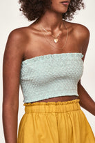 Girl wearing MIRTH women's smocked elastic savannah sleeveless cropped top set in blue frost cotton