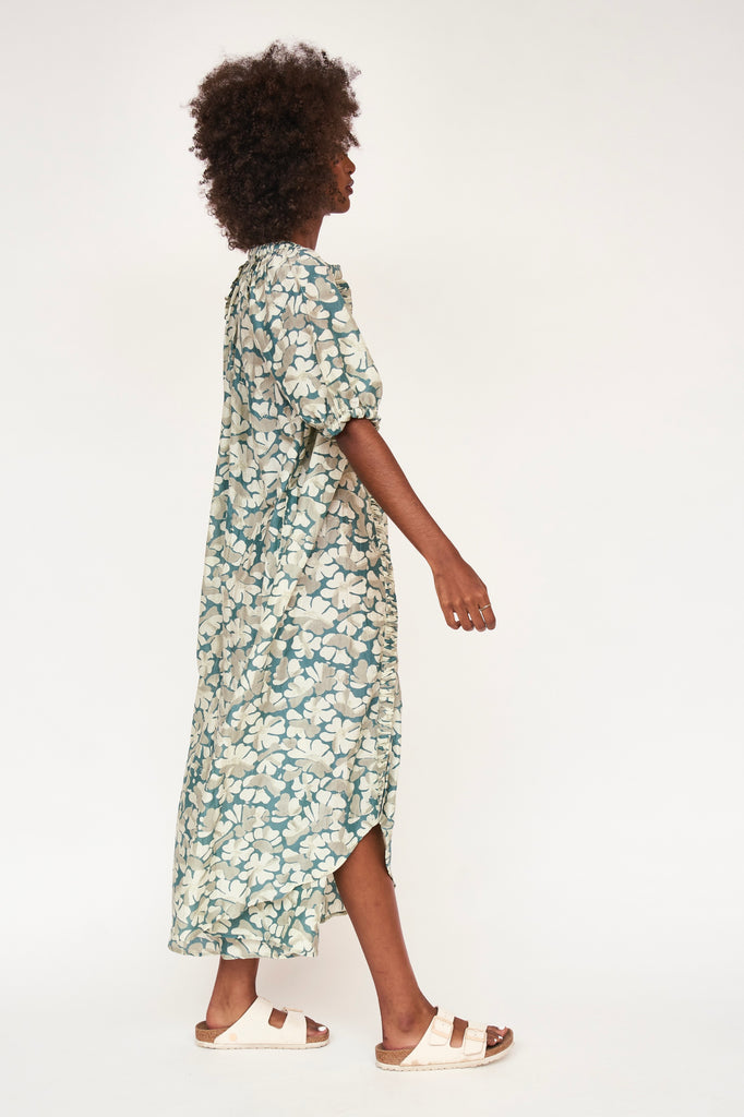 Girl wearing MIRTH women's long buttoned balloon sleeve somerset dress in plumeria blue floral print cotton