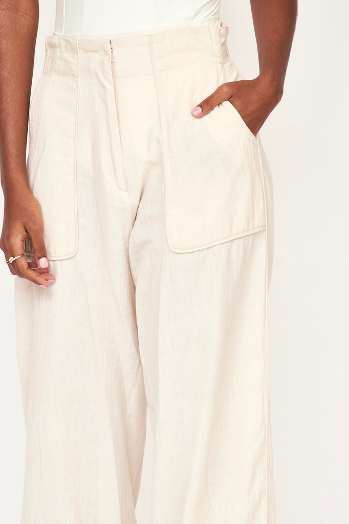 Girl wearing MIRTH women's high waist tailored resort tivot pant in parchment cream cotton
