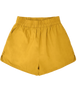 Girl wearing MIRTH women's wide leg elastic track shorts in gilded yellow cotton