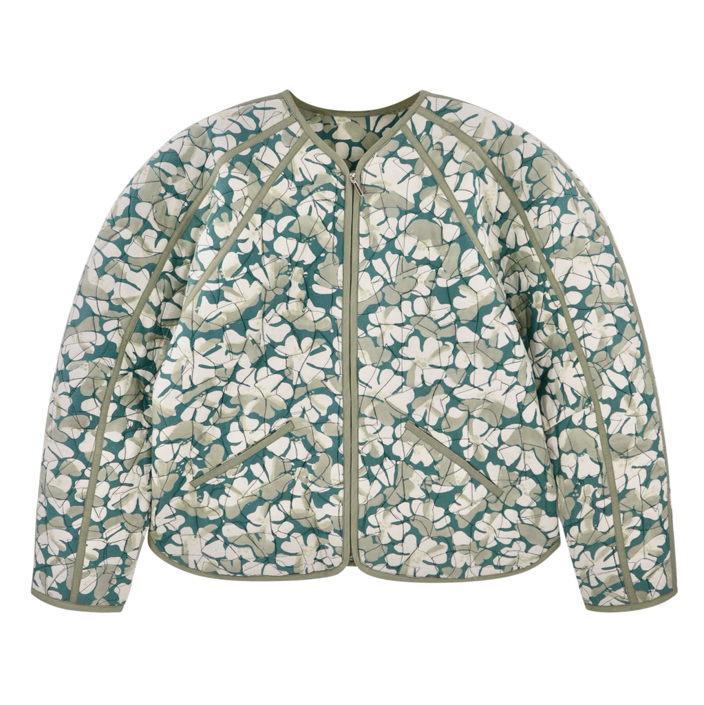 Girl wearing MIRTH women's front zip quilted turin jacket in plumeria blue floral print cotton silk