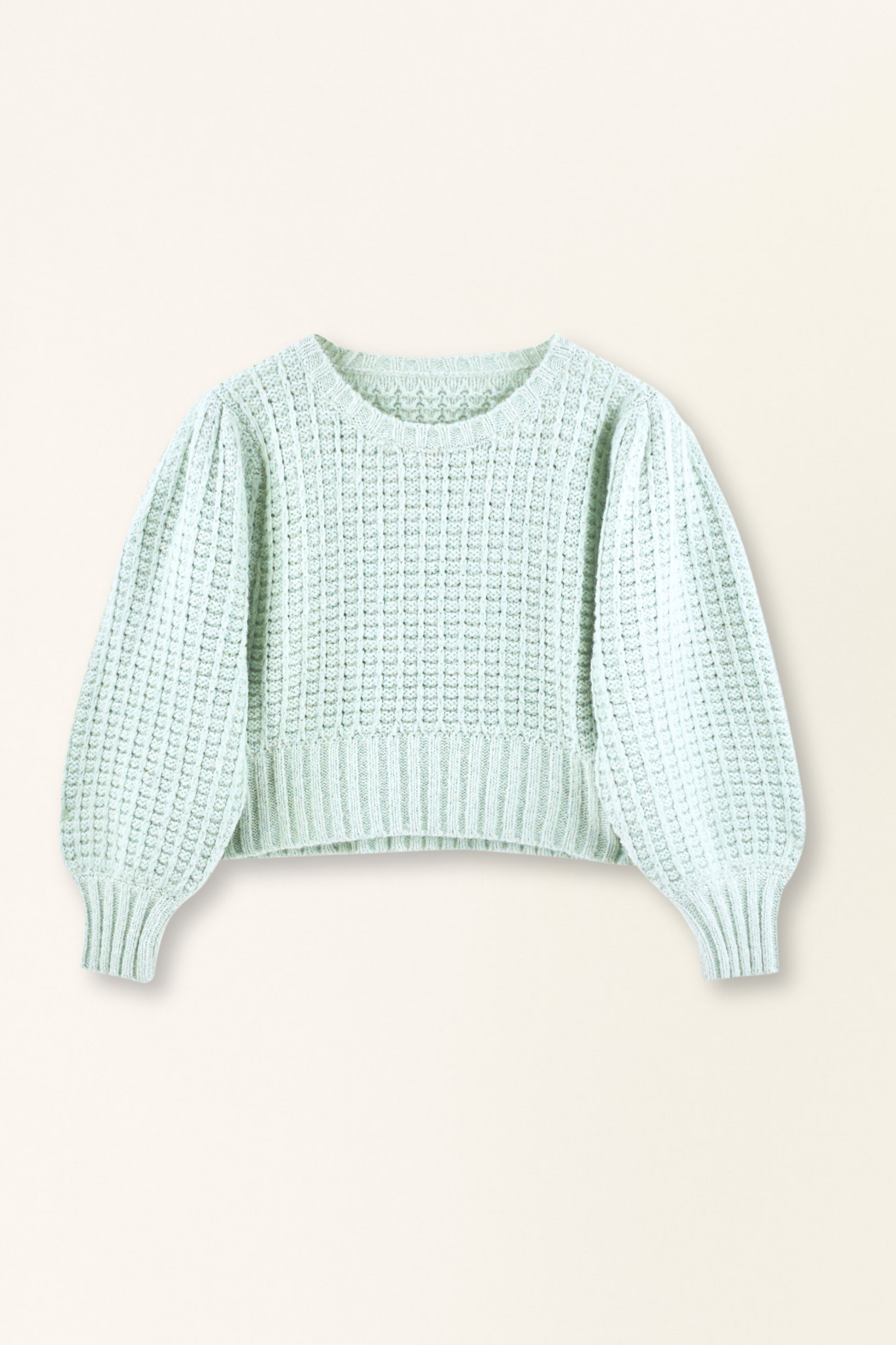 Light blue sweater on a beige background
