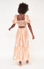 Girl wearing MIRTH women's v neck cutout spaghetti strap puff sleeve valencia long dress in peach conch ikat