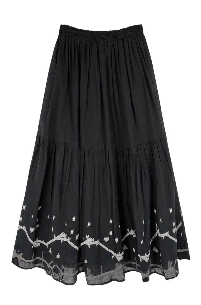 Girl wearing MIRTH women's long flowy paros skirt set in handloomed black carnival jamdani