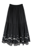 Girl wearing MIRTH women's long flowy paros skirt set in handloomed black carnival jamdani