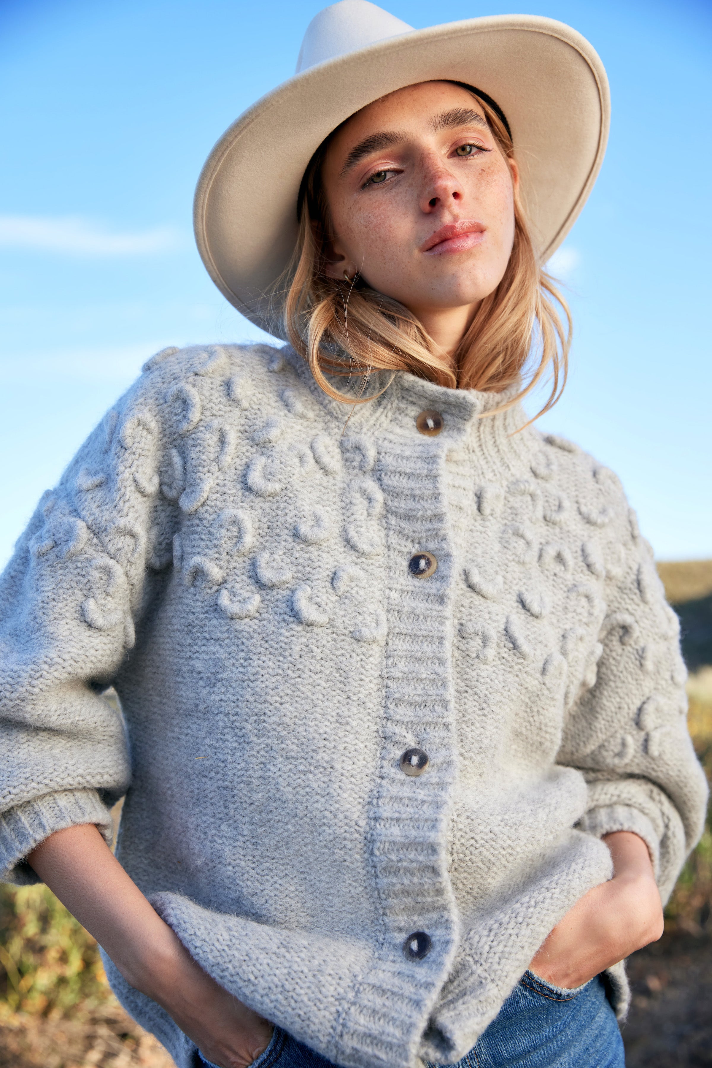 Girl wearing MIRTH women's knit cusco cardigan sweater in dove grey wool