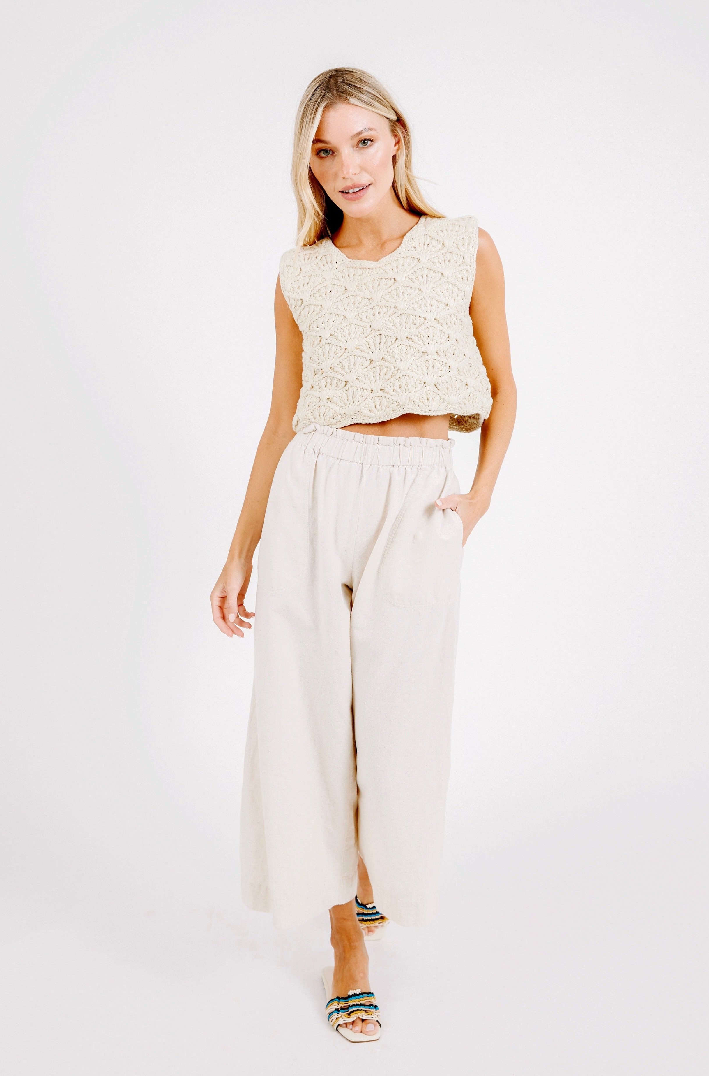 Girl wearing MIRTH women's paperbag waist wide leg palazzo pant in oatmeal beige