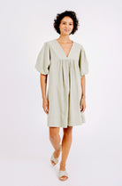 Girl wearing MIRTH women's balloon sleeve short" belem" vacation dress and coverup dress in sage green cotton