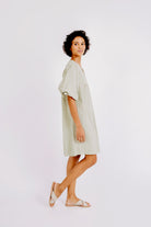 Girl wearing MIRTH women's balloon sleeve short" belem" vacation dress and coverup dress in sage green cotton