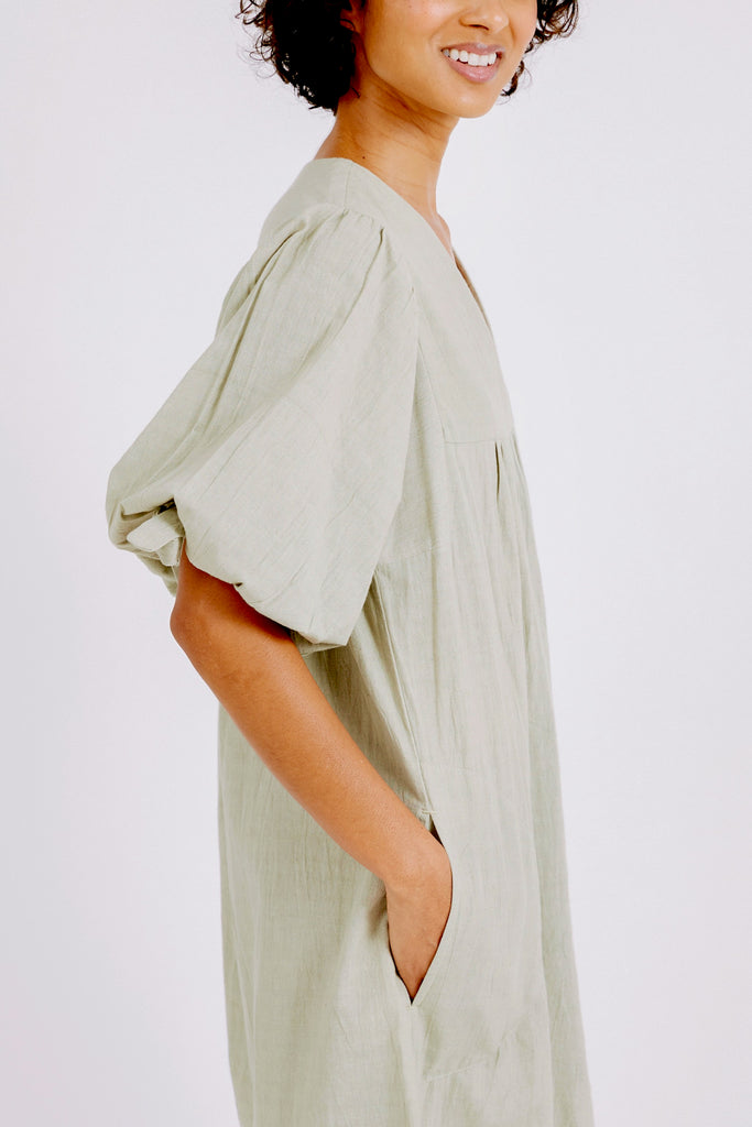 Girl wearing MIRTH women's balloon sleeve short" belem" vacation dress and coverup dress in sage green cotton