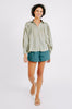Girl wearing MIRTH women's buttoned long sleeve kerala pintucked blouse in sage green cotton