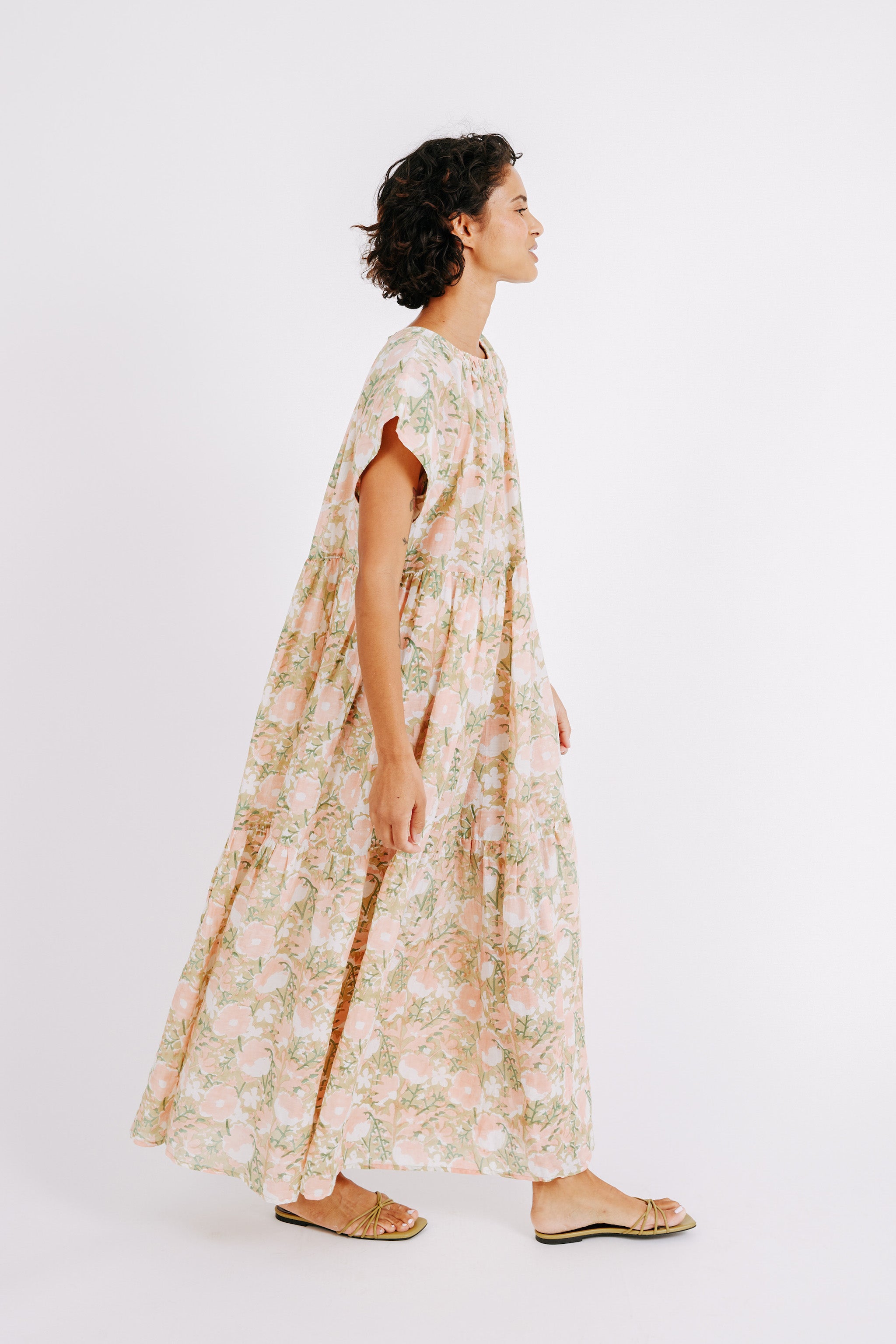 Girl wearing MIRTH women's long tiered short sleeve vienna maxi dress in snapdragon bloom pink floral print cotton