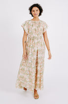 Girl wearing MIRTH women's long tiered short sleeve vienna maxi dress in snapdragon bloom pink floral print cotton
