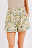 Girl wearing MIRTH women's wide leg elastic cotton track shorts in rose bloom pink floral print
