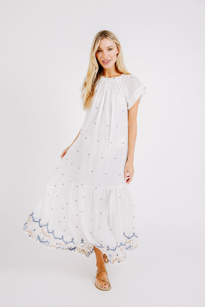 Girl wearing MIRTH women's long tiered short sleeve vienna maxi dress in white carnival handloomed cotton jamdani 