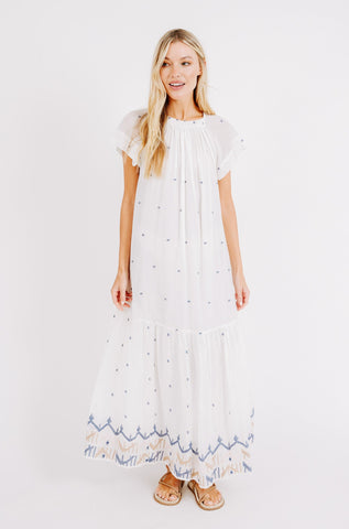Girl wearing MIRTH women's long tiered short sleeve vienna maxi dress in white carnival handloomed cotton jamdani 