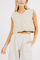 Girl wearing MIRTH women's knit sleeveless tahiti tank top coverup in natural macrame cream