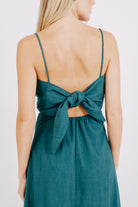 Girl wearing MIRTH women's tie back cutout deia midi sundress in spruce green poplin