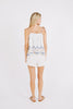Girl wearing MIRTH women's sleeveless mykonos top with scalloped tie straps in white carnival handloomed cotton jamdani