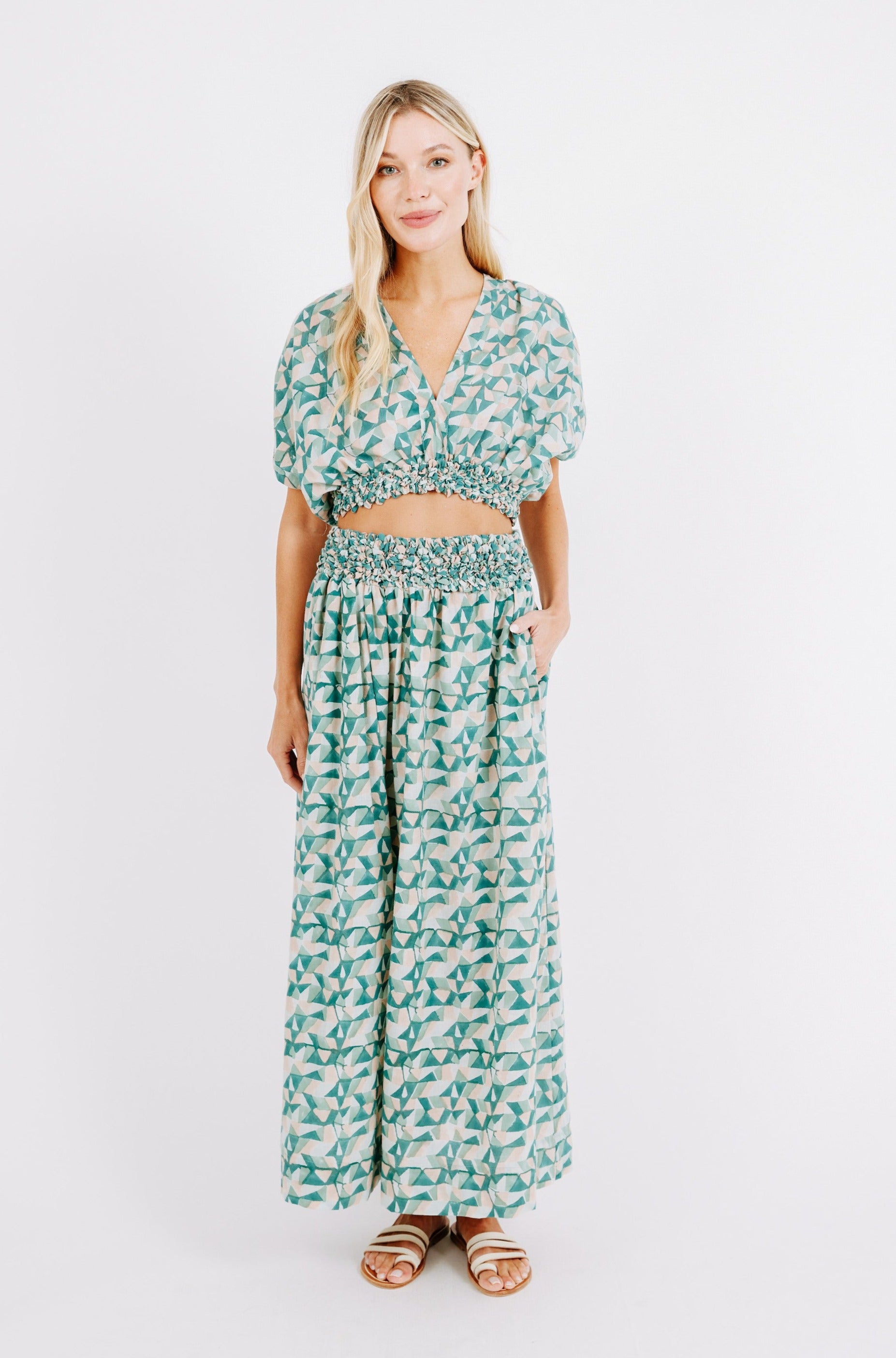 Girl wearing MIRTH women's smocked elastic waist cropped granada top set in seaglass green