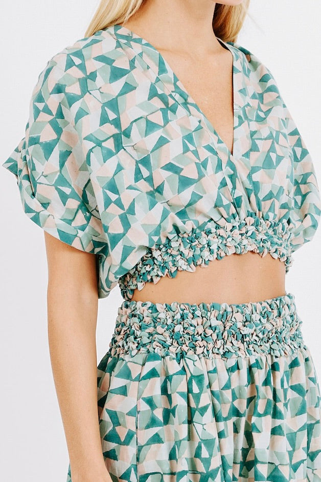 Girl wearing MIRTH women's smocked elastic waist cropped granada top set in seaglass green