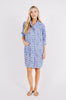 Girl wearing MIRTH women's short button marfa shirt camp dress in azure ikat blue cotton