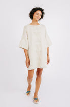 Girl wearing MIRTH women's knit short Osaka sweater dress in bone cream