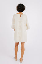 Girl wearing MIRTH women's knit short Osaka sweater dress in bone cream