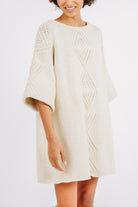 Girl wearing MIRTH women's knit short Osaka sweater dress in bone cream