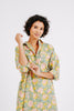 Girl wearing MIRTH women's buttoned kyoto midi house dress in camelia bloom green floral print cotton 