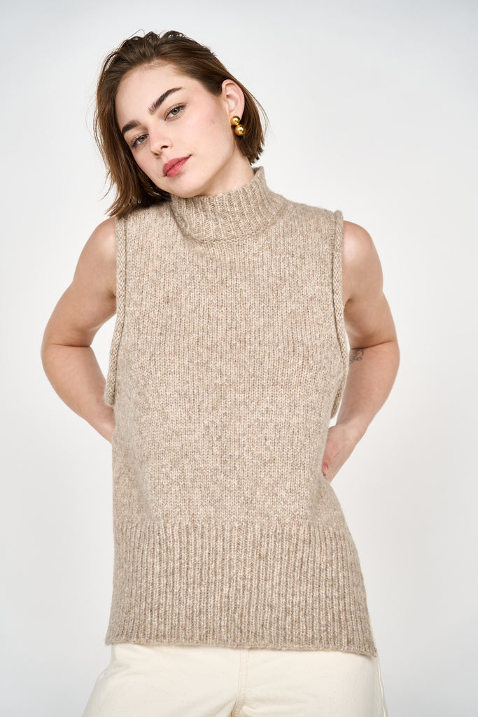 Girl wearing MIRTH women's knit aspen high neck open side vest in camel brown wool