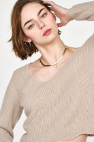 Girl wearing MIRTH women's knit v neck bellagio sweater in taupe brown wool