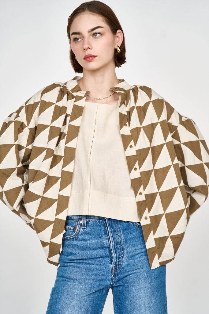 Girl wearing MIRTH women's quilted button up bergen jacket in tannin brown ecru cream patchwork