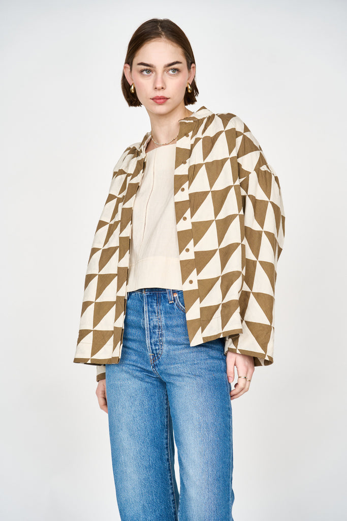 Girl wearing MIRTH women's quilted button up bergen jacket in tannin brown ecru cream patchwork