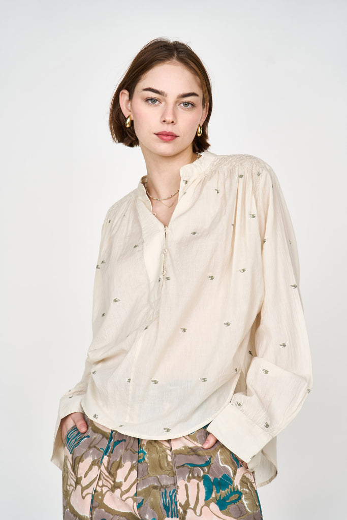 Girl wearing MIRTH women's button up smocked lightweight florence blouse in hand woven ivory jamdani cotton