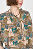 Girl wearing MIRTH women's button up smocked lightweight florence blouse in brown moss reef print cotton