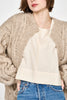 Girl wearing MIRTH women's handknit cortina cable cardigan sweater in camel brown wool