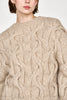 Girl wearing MIRTH women's handknit cortina cable pullover sweater in camel brown wool