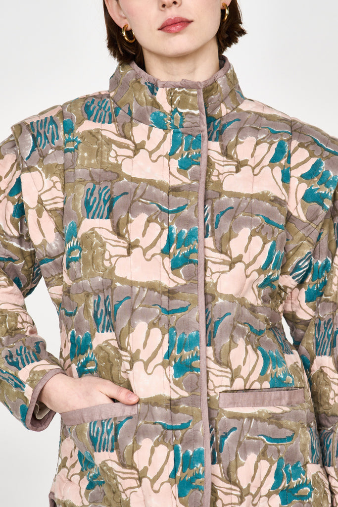 Girl wearing MIRTH women's quilted helsinki jacket in brown moss reef blockprint