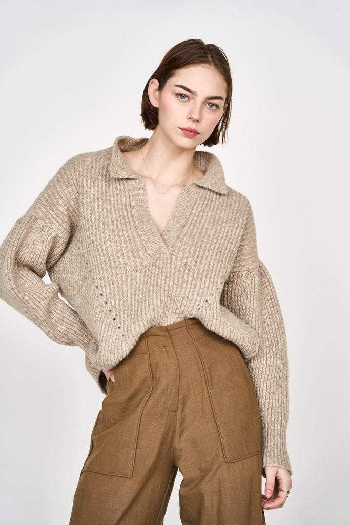 Girl wearing MIRTH women's v neck pullover sweater in camel brown wool