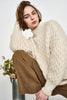Girl wearing MIRTH women's pullover hand knit honeycomb weave megeve turtleneck sweater in ivory alpaca wool