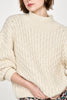 Girl wearing MIRTH women's pullover hand knit honeycomb weave megeve turtleneck sweater in ivory alpaca wool