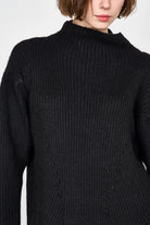 Girl wearing MIRTH women's knit pichu pichu sweater dress in black wool