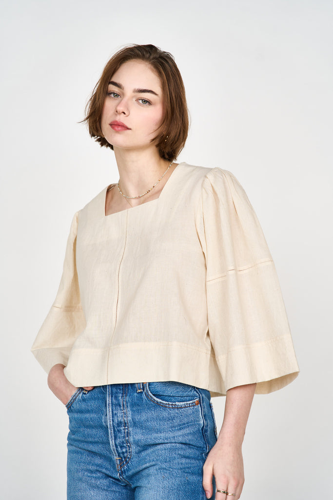 Girl wearing MIRTH women's pullover square neck cropped provence top in cream ecru cotton