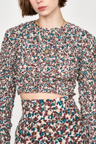 Girl wearing MIRTH women's long sleeve smocked elastic shoreditch top in purple red amaryllis print